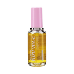 Klar flaske med gul væske og lyserød hætte. Etiket: "YUZU VITA-C AMPOULE" i hvid tekst.