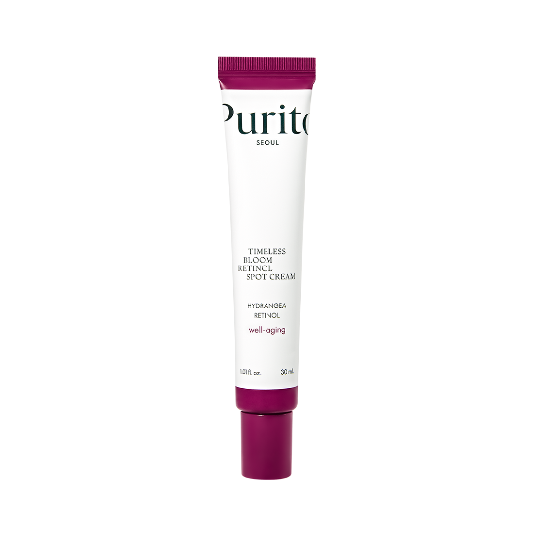 Hvid tube med lilla låg, "Purito SEOUL Timeless Bloom Retinol Spot Cream" står på tuben.