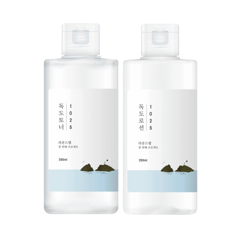 To gennemsigtige flasker med toner, enkel etiket og havdesign nederst, 200 ml hver.