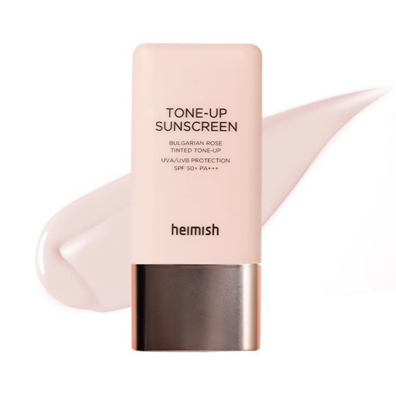 Lyserød tube med tekst "Tone-Up Sunscreen", Heimish. Pink creme baggrund.