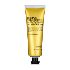 Gylden tube med sort tekst: "Benton Shea Butter & Coconut Hand Cream". 50g, dermatologisk testet.
