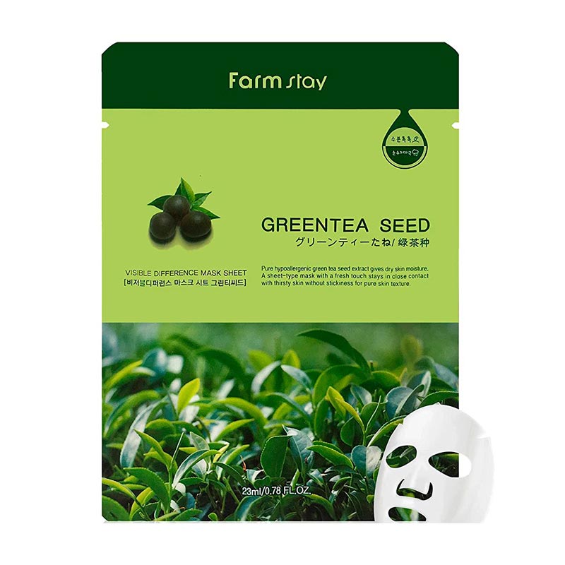 Grøn emballage med grøn teblade, tekst "Green Tea Seed" og en hvid ansigtsmaske illustration.