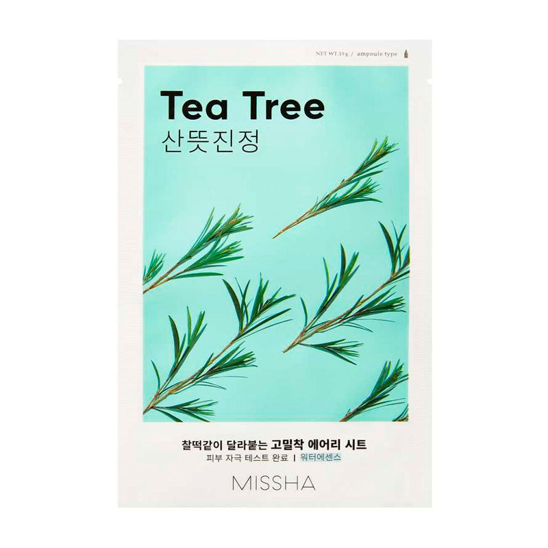 Lyseblå pakke med te-træsgrene, teksten "Tea Tree" og "Missha" nederst.