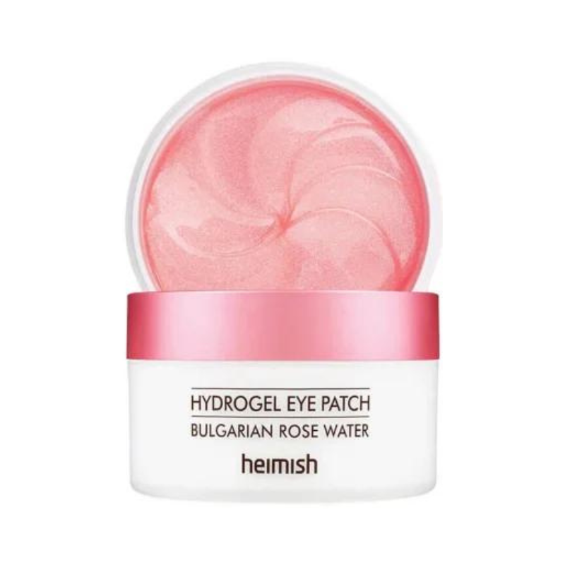 Rund beholder med åbent pink låg, viser lyserøde gel-øjenlapper indeni. Hvid beholder med tekst.