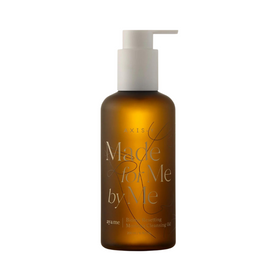 Brun flaske med hvid pumpe, tekst "Made for Me by Me", "Biome Resetting Moringa Cleansing Oil".