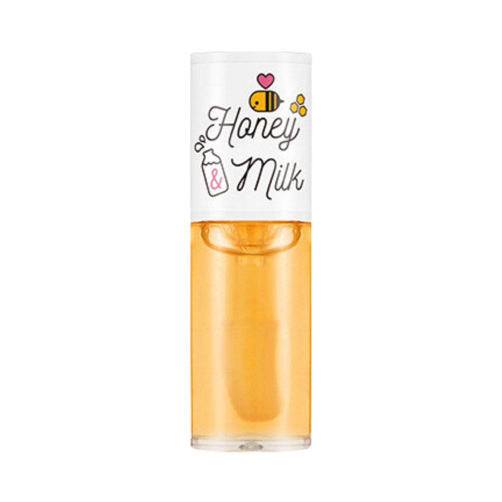 Klar flaske med hvid hætte, dekoreret med bier og tekst "Honey & Milk" i sød stil.