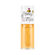 Klar flaske med hvid hætte, dekoreret med bier og tekst "Honey & Milk" i sød stil.