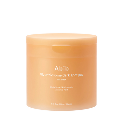 Peachfarvet krukke med tekst: "Abib Glutathiosome dark spot pad Vita touch".