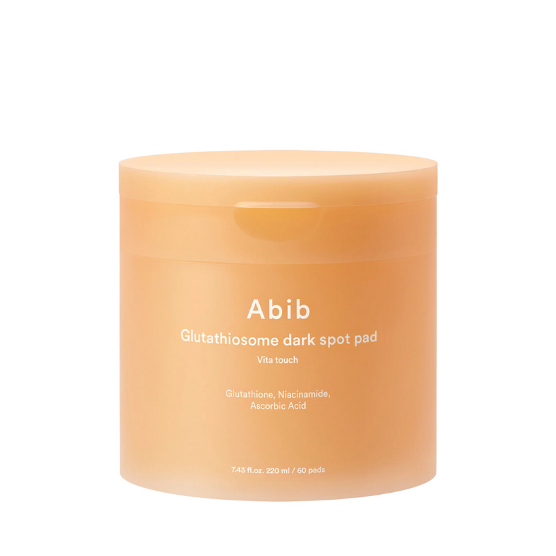 Peachfarvet krukke med tekst: "Abib Glutathiosome dark spot pad Vita touch".