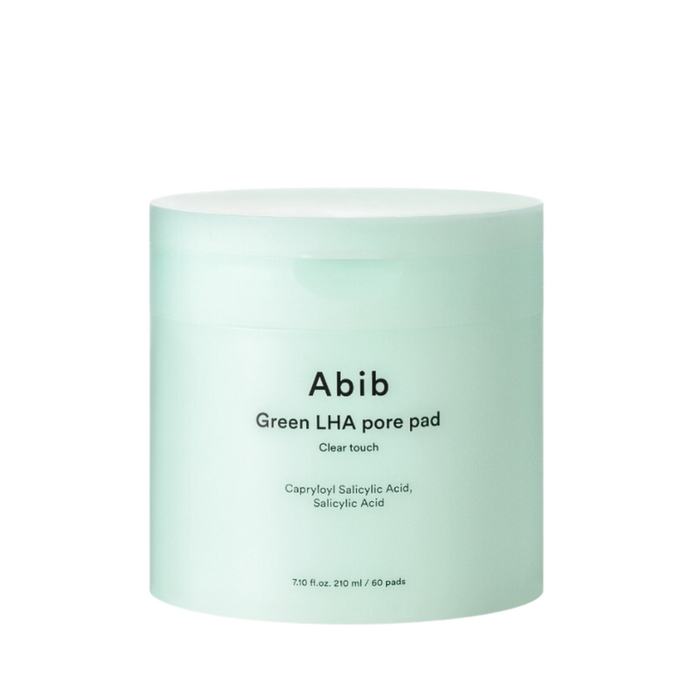 Lysegrøn cylinderbeholder med teksten "Abib Green LHA pore pad Clear touch" og ingredienser.