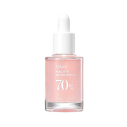 Klar flaske med lyserød væske og hvid dråbeprop. Etikette: "Anua Peach 70 Niacinamide Serum".