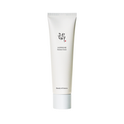 Hvid tube med tekst "Dynasty Cream" og "Beauty of Joseon" samt koreanske tegn.