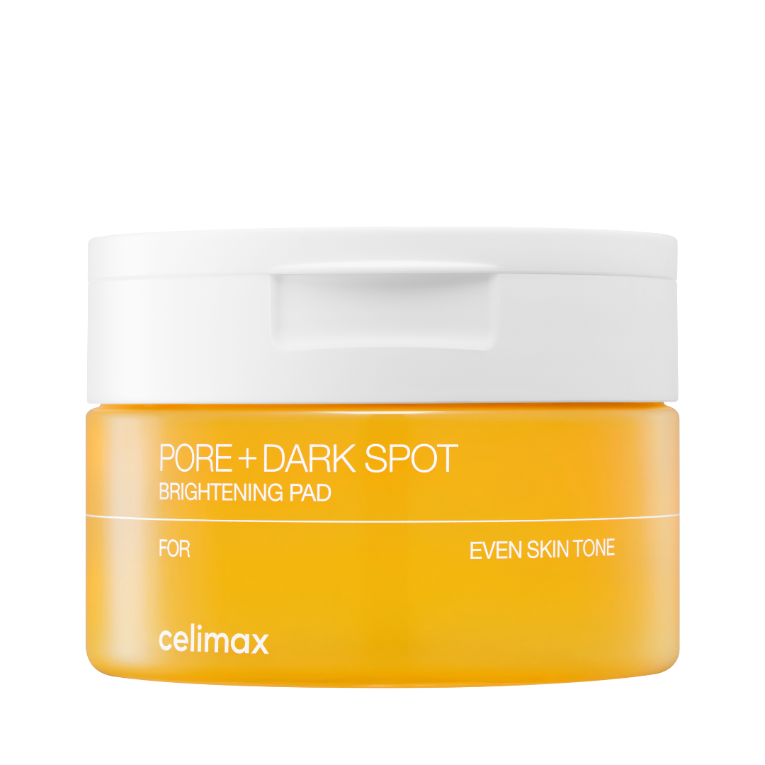 Orange Celimax krukke med hvidt låg, tekst: "Pore + Dark Spot Brightening Pad" og "Even Skin Tone".