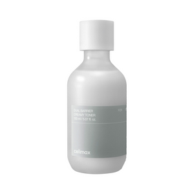 Hvid flaske med grå etiket, tekst "Dual Barrier Creamy Toner" og volumen 150 ml.