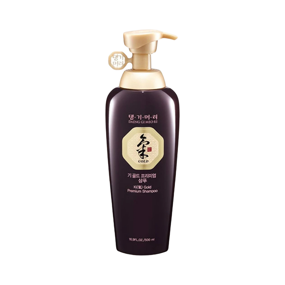 Mørk flaske med pumpe, mærket "Daeng Gi Meo Ri Ki Gold Premium Shampoo" i guld og sort tekst.