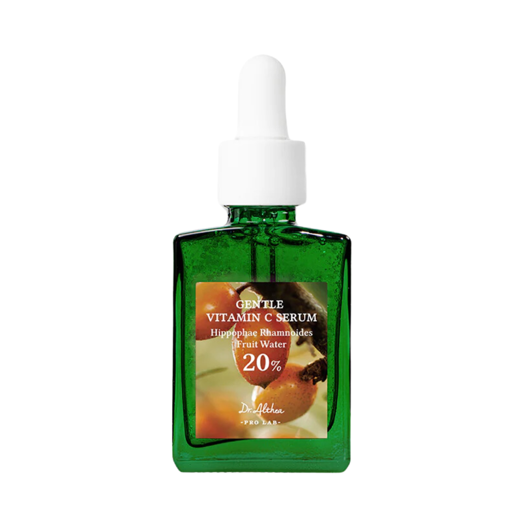 Grøn glasflaske med hvid dråbehætte, etiket med "Gentle Vitamin C Serum" og 20% tekst.