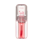 Transparent flaske med pink væske og applikator, mærket "Etude" og "oil tint" på låget.