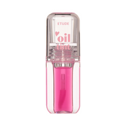 Klar beholder med pink væske og etiketten "Etude" og "oil tint" på låget.