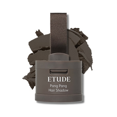 Etude Pang Pang Hair Shadow i mørkebrun med applikator og krøllet pulver bagved.