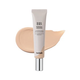 Tube af Heimish Moringa Ceramide BB Cream (#21 Light Beige) med beige swatch i baggrunden.