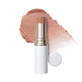 Beige balsamstift med hvid hætte og farvesmear.