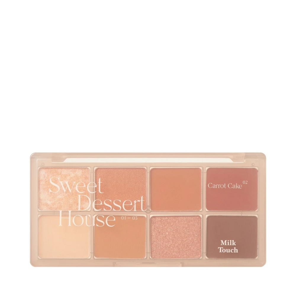 Makeup-palette med otte varme nuancer, inkl. "Carrot Cake" og "Milk Touch" tekst på paletten.