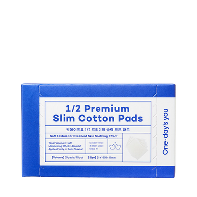 Blå og hvid pakke med teksten "1/2 Premium Slim Cotton Pads" og produktbeskrivelse.