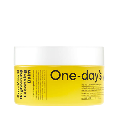 Gul krukke med hvidt låg. Sort tekst: "One-day's you - Pro Vita-C Brightening Cleansing Balm".