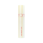 Cremetube med lyserød skrift: "JUICY LASTING TINT". Minimalistisk design.