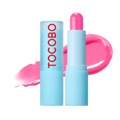 Lyseblå tube med rød "TOCOBO", pink læbepomade og pink glans i baggrunden.