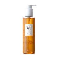 Klar flaske med ravfarvet væske, hvid pumpe og etiket med koreansk tekst og "Ginseng Cleansing Oil".