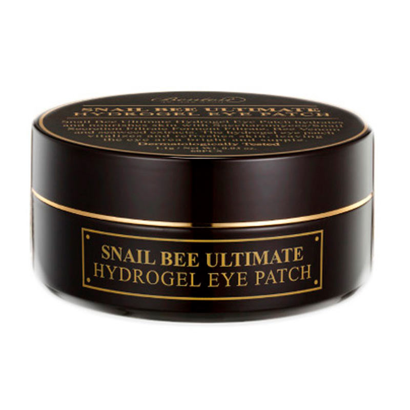 Mørkebrun rund beholder med guldtekst: "Snail Bee Ultimate Hydrogel Eye Patch."