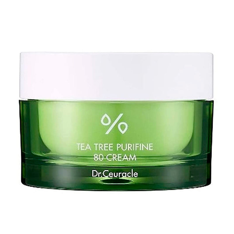 Grøn krukke med hvidt låg, tekst "Tea Tree Purfine 80 Cream" og "Dr. Ceuracle" på forsiden.