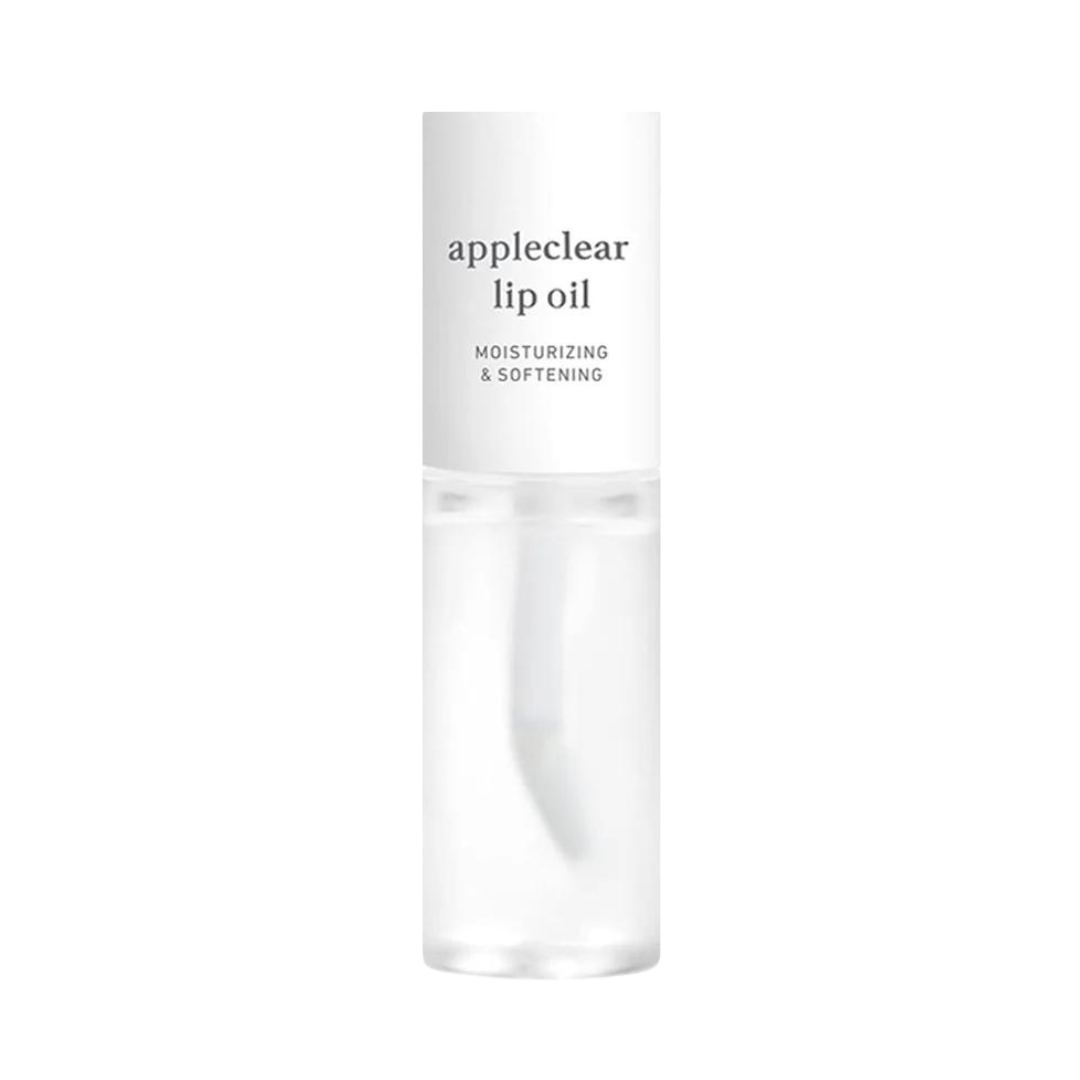 Klar flaske med hvid hætte, mærket "appleclear lip oil" og "moisturizing & softening."