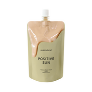 Beige pose med peach-farvet creme, teksten "shaishaishai Positive Sun, Tanning Watery Cream SPF22".