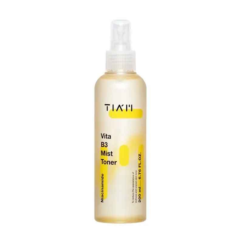 Sprayflaske med klar hætte, mærket "TIA'M Vita B3 Mist Toner" og gule detaljer.